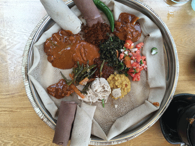 Delicious Ethiopian dishes served on a plate of injera